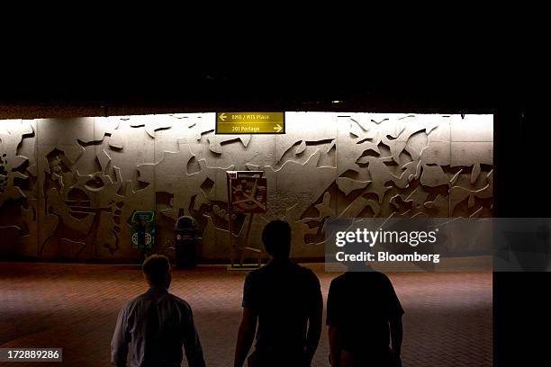 Commuters walk through an underground walkway in Winnipeg, Manitoba, Canada, on Thursday, July 4, 2013. Canada extended the longest streak of...