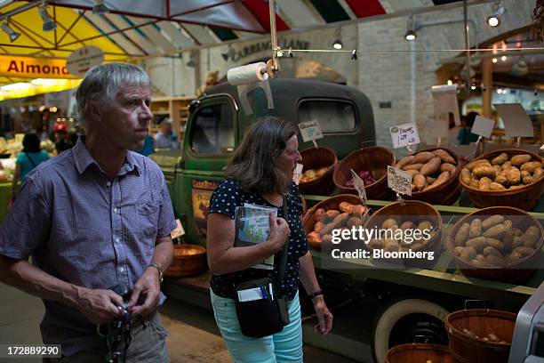 People walk through the Forks Market in Winnipeg, Manitoba, Canada, on Thursday, July 4, 2013. Canada extended the longest streak of merchandise...