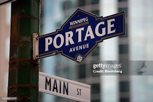 Signs mark the main intersection of Portage Avenue and Main Street in Winnipeg, Manitoba, Canada, on Thursday, July 4, 2013. Canada extended the...