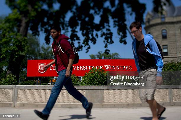 Students walk past a University of Winnipeg sign in this photo taken with a tilt-shift lens in Winnipeg, Manitoba, Canada, on Thursday, July 4, 2013....