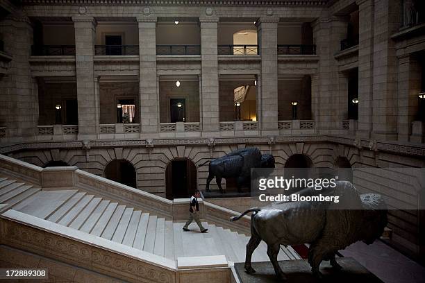 Man walks through the Manitoba Legislative Building in Winnipeg, Manitoba, Canada, on Thursday, July 4, 2013. Canada extended the longest streak of...