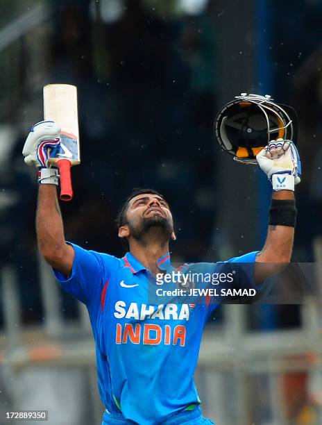 Indian cricket team captain Virat Kohli celebrates after scoring his century during the fourth match of the Tri-Nation series between India and West...