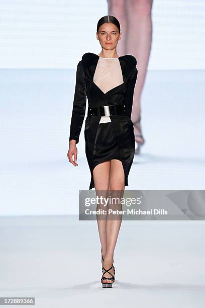 Model walks the runway at the Ece Goezen, Nazli Bozdag, Nevra Karaca No. 7 Show during Mercedes-Benz Fashion Week Spring/Summer 2014 at Brandenburg...