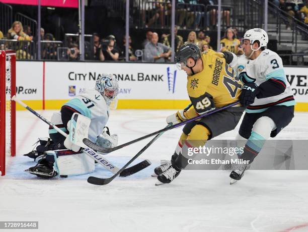 Philipp Grubauer of the Seattle Kraken blocks a shot by Ivan Barbashev of the Vegas Golden Knights as Will Borgen of the Kraken defends in the second...