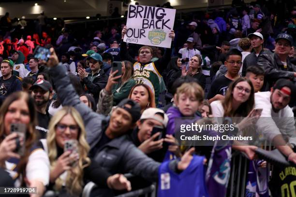 Seattle Sonics fan holds a sign after the Rain City Showcase in a preseason NBA game between the LA Clippers and the Utah Jazz at Climate Pledge...