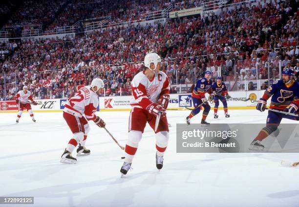 Steve Yzerman of the Detroit Red Wings skates on the ice as teammate Dino Ciccarelli skates with the puck during Game 7 of the 1996 Conference...