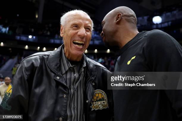 Lenny Wilkens, former Seattle Sonics head coach, talks with assistant coach Jason Terry of the Utah Jazz before the Rain City Showcase in a preseason...