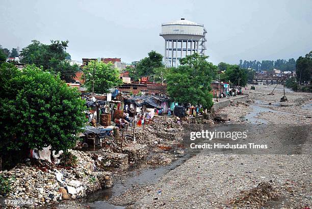 Slums along Rispana river bedside on July 5, 2013 in Dehradun, India. Over the years unauthorised colonies have encroached the river bed of seasonal...