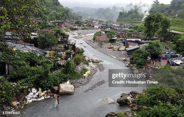 Slums along Rispana river bedside on July 5, 2013 in Dehradun, India. Over the years unauthorised colonies have encroached the river bed of seasonal...