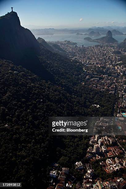 The Christ the Redeemer statue stands on top of Corcovado Mountain in this aerial photograph of Rio de Janeiro, Brazil, on Thursday, July 4, 2013....