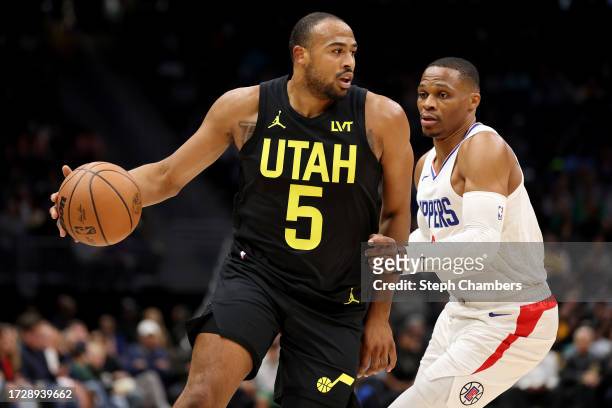 Talen Horton-Tucker of the Utah Jazz dribbles against Russell Westbrook of the LA Clippers during the first quarter of the Rain City Showcase in a...