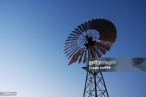 silhouette of windmill - groundwater stock pictures, royalty-free photos & images