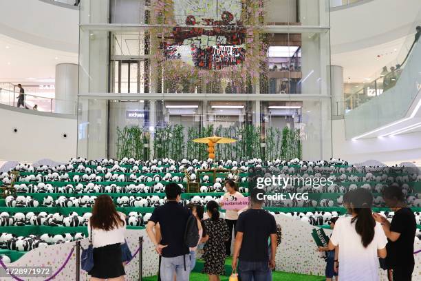 Paper sculptures of giant pandas are on display during the "1864 Panda Tour" exhibition at Changsha International Finance Square on September 29,...