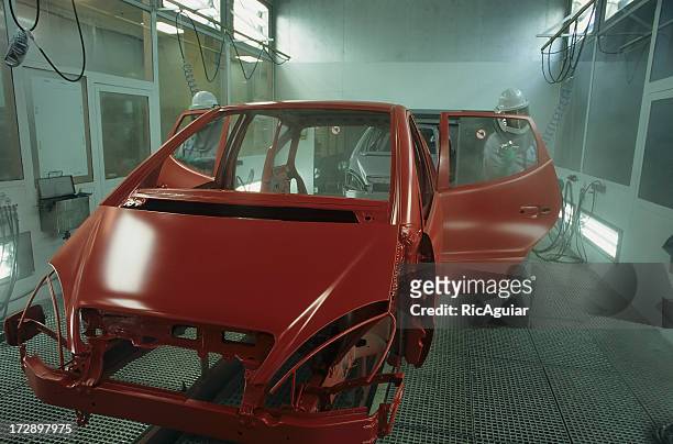 unfinished frame of red car in auto shop - car paint stock pictures, royalty-free photos & images