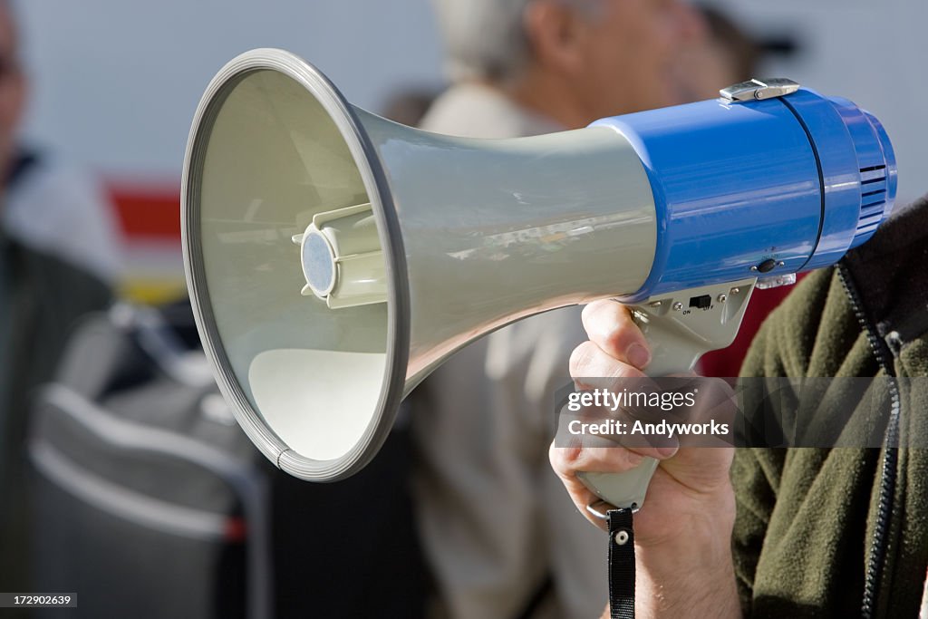 Blue megaphone being held in an action position