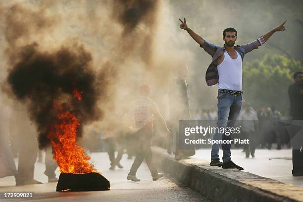 Supporters of former Egyptian President Mohammed Morsi burn tires along a bridge in protest over his removal by the Egyptian military on July 5, 2013...