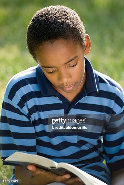 Boy Reading Scriptures Boy Reading Bible Photos and Premium High Res Pictures - Getty Images