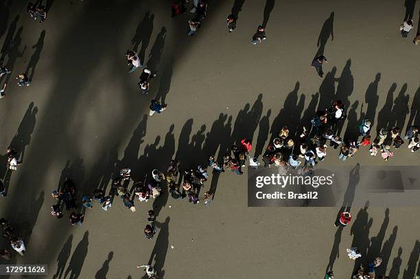 people and shadows - endurance walking stock pictures, royalty-free photos & images