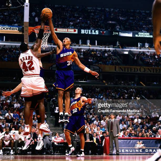 Shawn Marion of the Phoenix Suns goes up high to block a shot attempt by Elton Brand of the Chicago Bulls during a 2000 NBA game at the United Center...