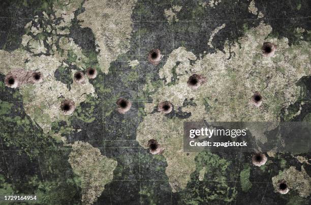 world peace in danger - peace symbol and world map on a wall with bullet holes - exercício militar imagens e fotografias de stock