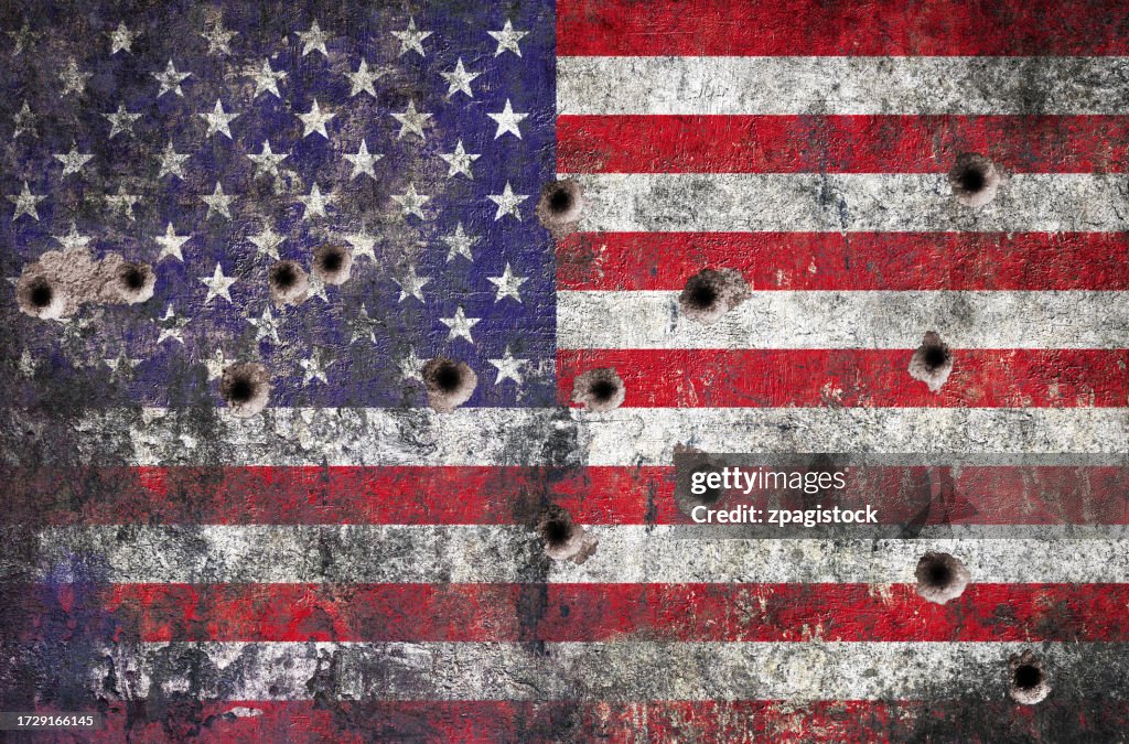 American flag mural on the wall with bullet holes - violence in the USA