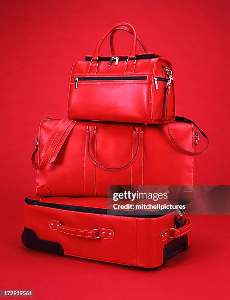 red luggage with a red background - luggage bag stock pictures, royalty-free photos & images