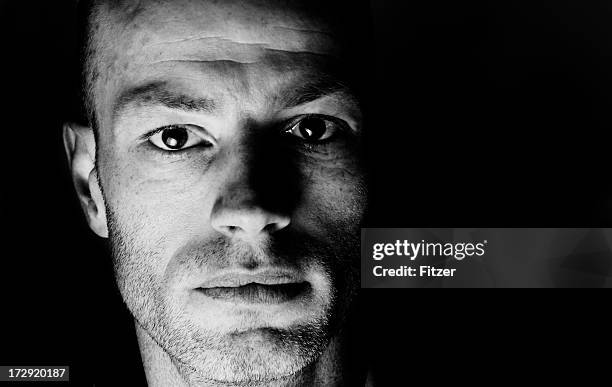 serious man in the dark - extreme close up face serious stock pictures, royalty-free photos & images
