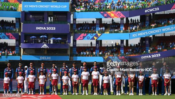 Players of Afghanistan line up for the National Anthems ahead of the ICC Men's Cricket World Cup India 2023 between India and Afghanistan at Arun...