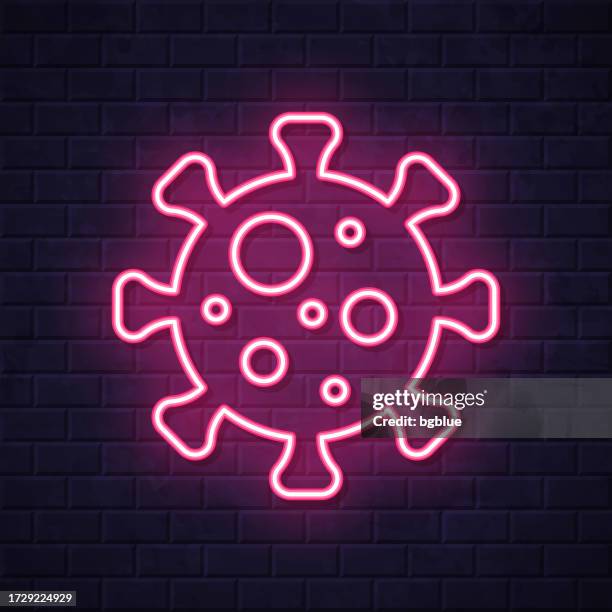 coronavirus cell (covid-19). glowing neon icon on brick wall background - sars virus microscope stock illustrations