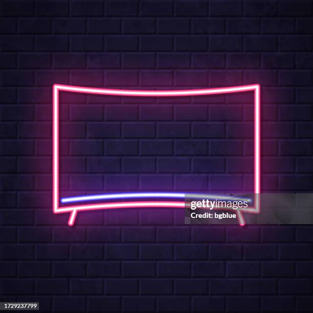 curved tv. glowing neon icon on brick wall background - digital display wall stock illustrations