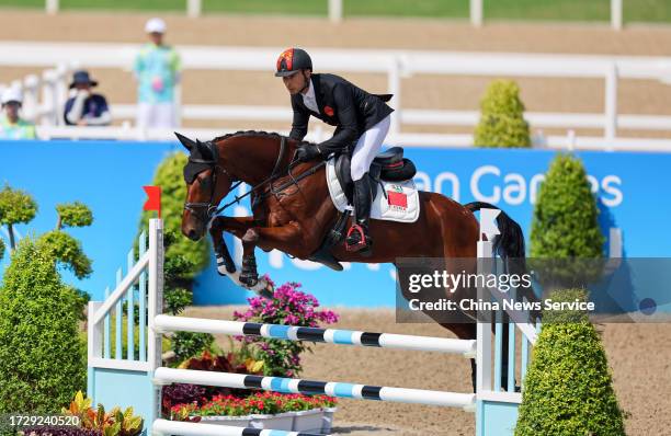 Hua Tian of Team China competes in the Equestrian - Eventing Jumping Individual Final on day nine of the 19th Asian Games at Tonglu Equestrian Centre...