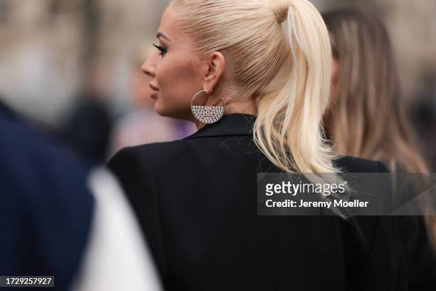 Guest is seen outside Chanel show wearing silver crystal Chanel earrings during the Womenswear Spring/Summer 2024 as part of Paris Fashion Week on...
