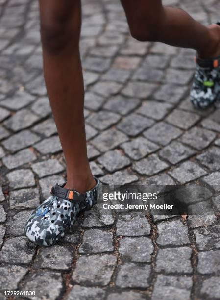Guest is seen outside Chanel show wearing army printed crocs during the Womenswear Spring/Summer 2024 as part of Paris Fashion Week on October 03,...