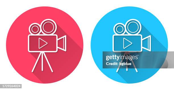 video camera with tripod. round icon with long shadow on red or blue background - digital camcorder stock illustrations