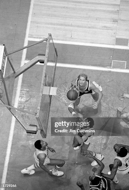 Julius Erving of the Philadelphia 76ers drives to the basket in what becomes known as "The Move" against Mark Landsberger and Kareem Abdul-Jabbar of...