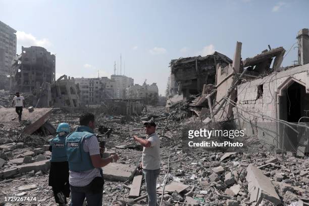 Palestinian journalists are working in the aftermath of an Israeli airstrike in Gaza, Palestine, on October 15, 2023.