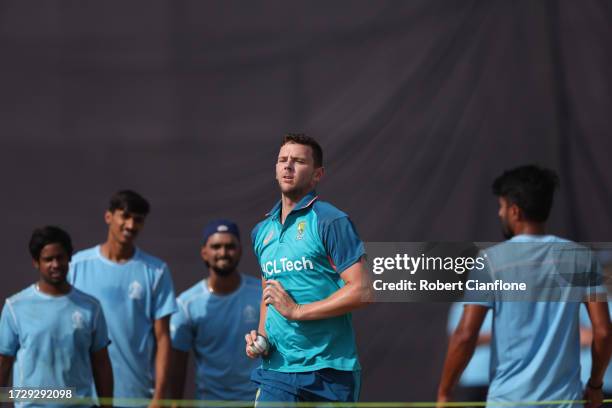 Net bowlers watch as Josh Hazlewood of Australia runs in to bowl during an Australian training session at the ICC Men's Cricket World Cup India 2023...