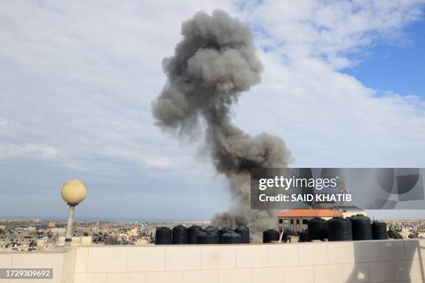 Smoke billows after an Israeli airstrike on the Rafah refugee camp, in the southern Gaza Strip on October 17, 2023. Relief convoys which have been...