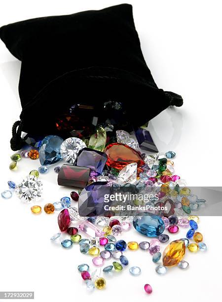 colored gemstones spilling out of black bag - diamond gemstone stock pictures, royalty-free photos & images