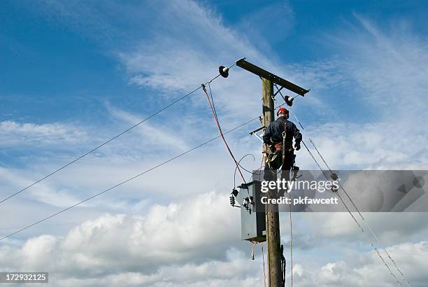 man at work - telephone pole stock pictures, royalty-free photos & images