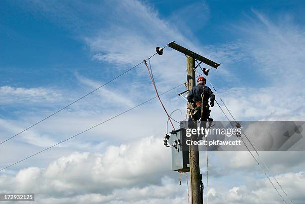 man at work - electricity tower stock pictures, royalty-free photos & images