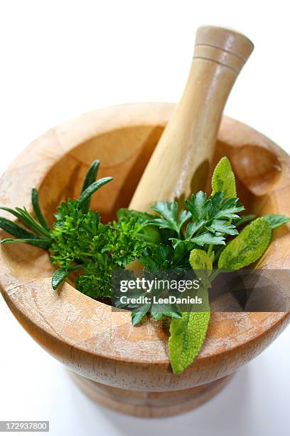 pestle and mortar with herbs - mortar and pestle stock pictures, royalty-free photos & images