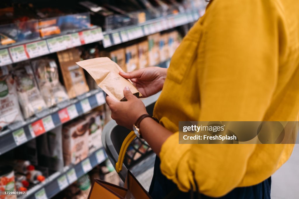 An Unrecognizable Woman Shopping At The Supermarket