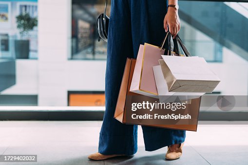 An Unrecognizable Beautiful Woman Holding Her Shopping Bags An Unrecognizable Beautiful Woman Holding Her Shopping Bags