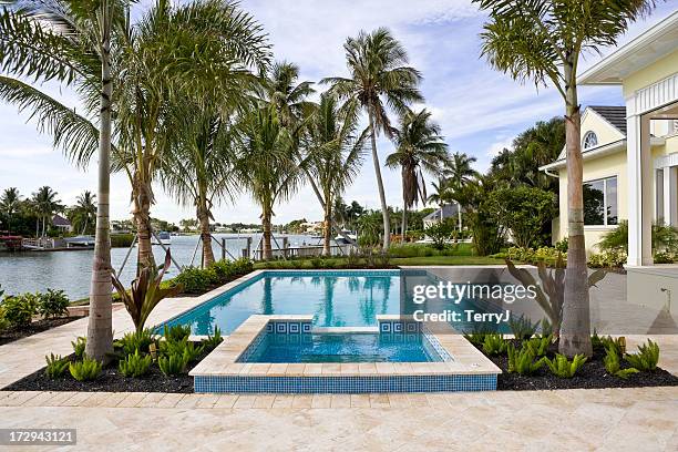 swimming pool and spa overlooking waterway - florida coastline stock pictures, royalty-free photos & images