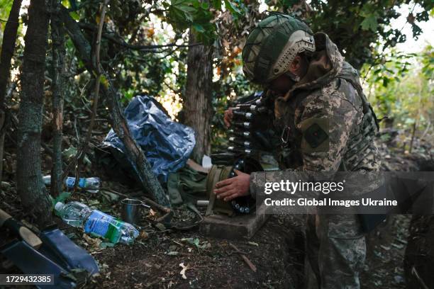 Ukrainian soldier loads ammo tape in automatic grenade launcher AGS-17 on October 7, 2023 in Ukraine. The Ukrainian army maintains its defense in the...