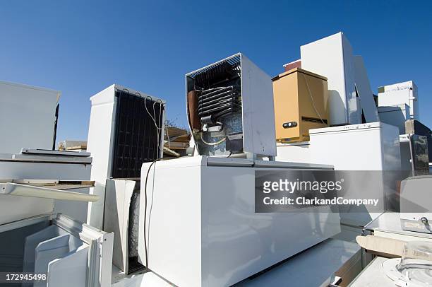 refrigerators piled up waiting to be recycled or scrapped. - obsolete stock pictures, royalty-free photos & images