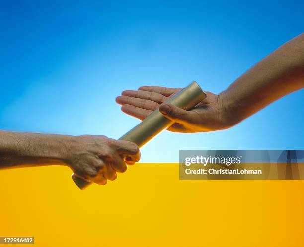 passing the baton - track and field baton stock pictures, royalty-free photos & images