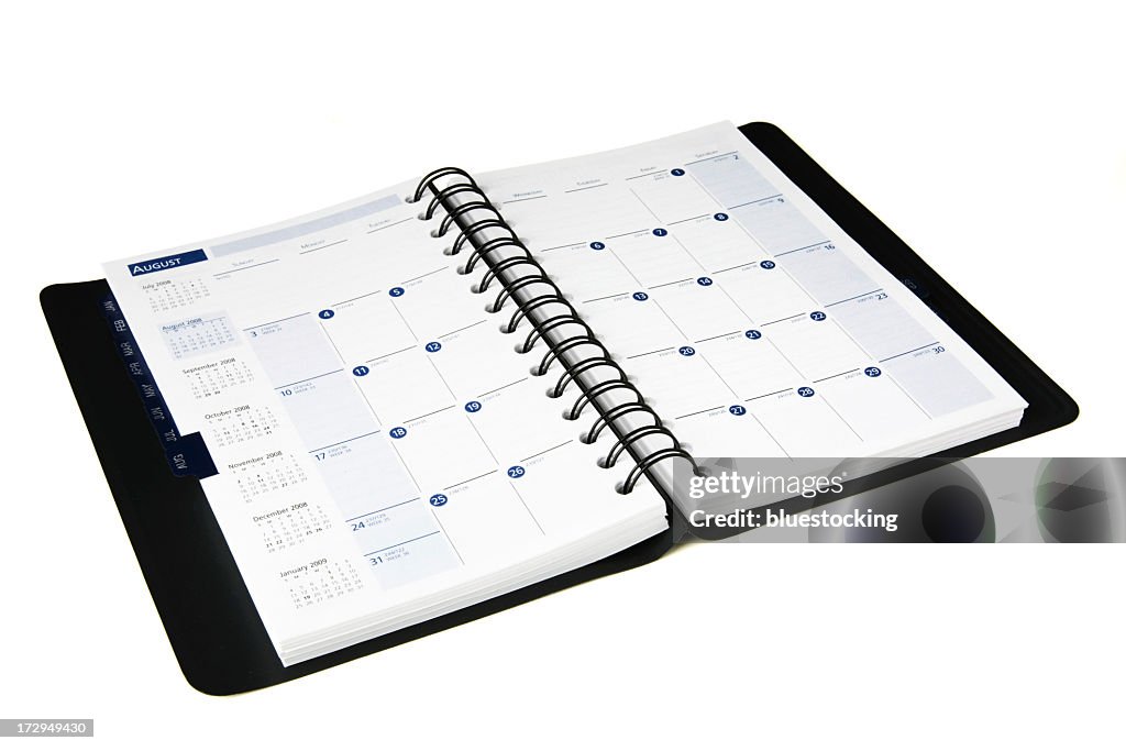 Open black daily planner with calendar isolated on white