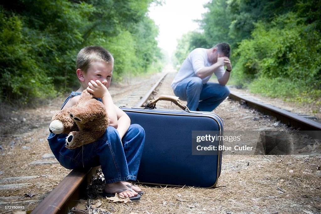 Desperate man and child on train tracks